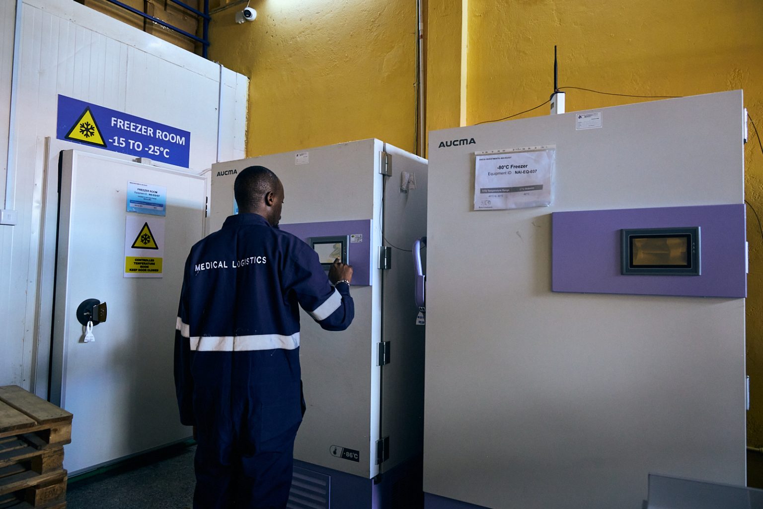 Technician operating a freezer room unit
